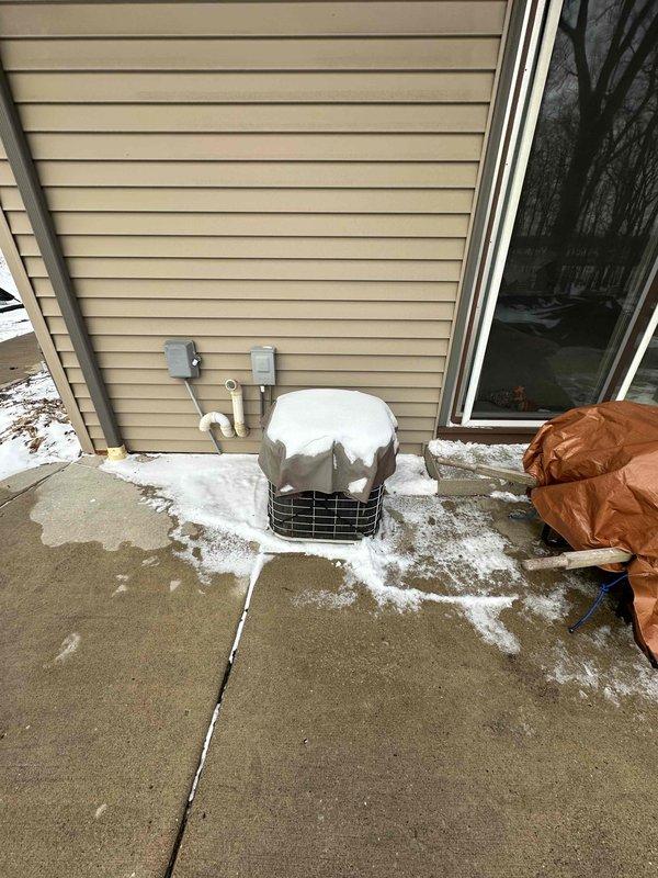 Conducted site assessment for HVAC replacement. Current system observed in basement utility area with existing furnace connected to PVC ventilation pipes and metal ductwork. Exterior inspection revealed snow-covered conditions with existing outdoor condenser unit covered for winter protection. Replacement recommendation provided based on evaluation of current installation configuration.