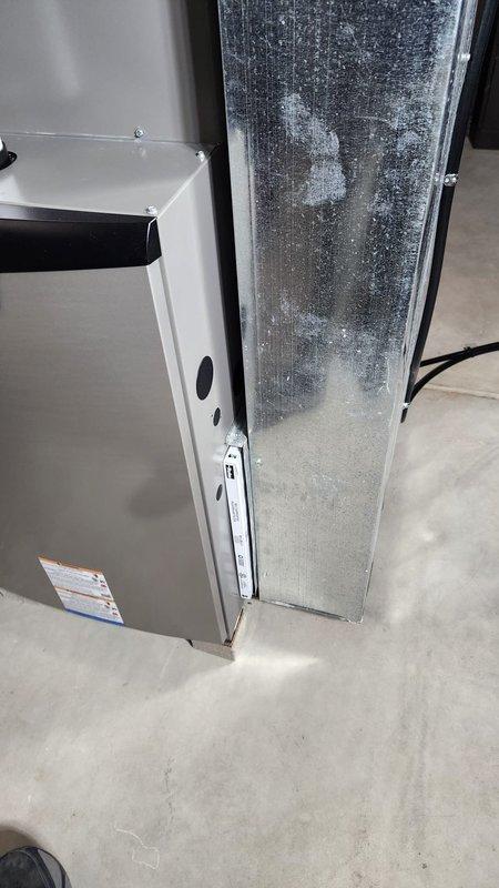 Successfully installed a new furnace unit in the basement utility room, properly connecting it to the existing ductwork and power supply. Noted frost formation on the adjacent cooling component which will require future monitoring to prevent potential system inefficiency.