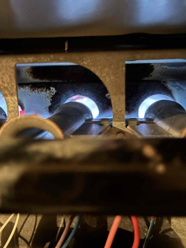 Responded to no-heat service call for furnace less than 10 years old. Upon inspection, determined burners were functioning properly with good blue flame pattern indicating appropriate gas combustion. Verified all electrical connections were secure and operational. No further issues identified; system now operating within normal parameters.