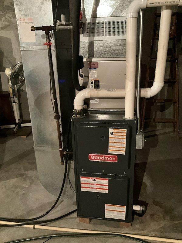 Completed HVAC replacement with installation of a new Goodman furnace system in basement mechanical room. Installation included proper PVC venting, condensate line configuration, and connection to existing ductwork. All components were properly secured and installed according to manufacturer specifications with appropriate pipe supports and ventilation requirements.