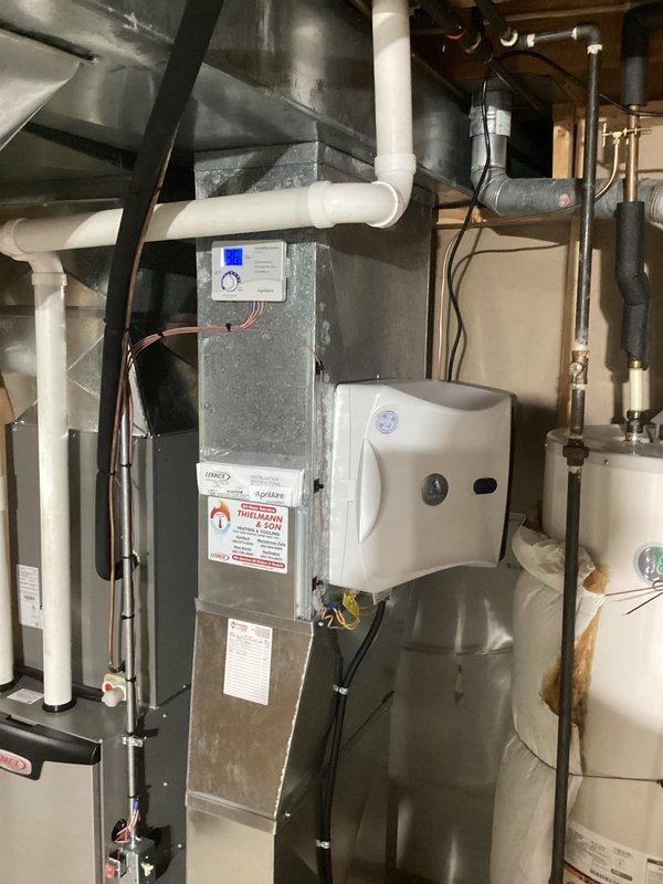 Successfully installed a complete residential HVAC system in utility room, featuring a high-efficiency furnace with digital control interface and integrated indoor air quality component. System installation included proper PVC venting with code-compliant routing, connection to existing ductwork, and synchronization with digital thermostat for optimal temperature control and air filtration performance.