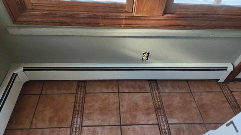 Successfully installed new baseboard heating units in the residence. Units were properly mounted along walls beneath windows with connection to existing copper piping system. Installation included connecting all necessary valves and pressure components, ensuring proper operation of the complete heating system.