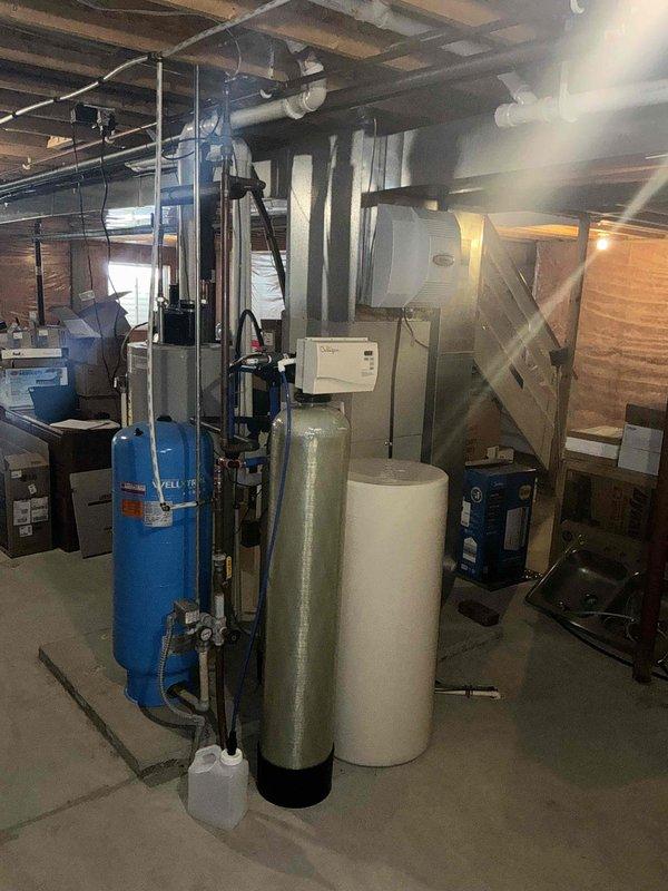 Conducted comprehensive assessment of existing HVAC system, including exterior condensing unit and indoor air handler/furnace configuration in utility room. Documented current water treatment system setup with pressure tank and associated plumbing components to ensure proper integration with new HVAC equipment during replacement planning.