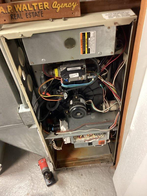 Completed seasonal tune-up on furnace at A.P. Walter Agency Real Estate property. Removed panels to conduct thorough inspection of internal components including motor, blower wheel, and circuit board. All electrical connections were checked and tightened, with system operation confirmed to be within normal parameters despite minor rust on lower metal surfaces.