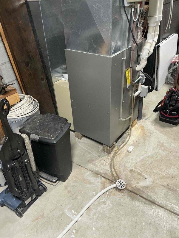 Conducted a thorough assessment of existing HVAC system in utility area. Documented furnace condition showing considerable wear with access panel removed for internal inspection. System features standard metal ductwork, PVC drainage pipes, and electrical connections that require upgrading. Recommended full replacement of the aging unit with a more efficient model to improve performance and reliability.