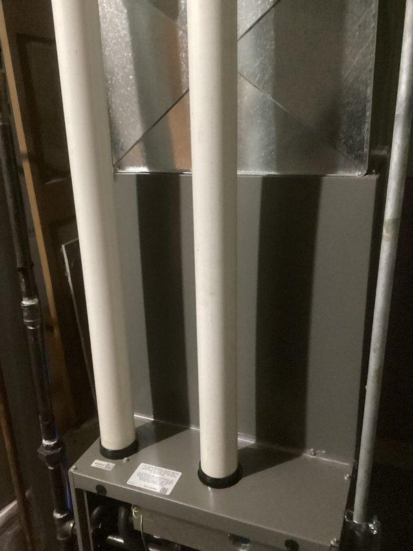 Performed comprehensive HVAC tune-up on customer's furnace system. Inspected PVC intake and exhaust venting for proper installation and airflow, confirming no blockages or damage present. Visual assessment of ductwork connections showed proper sealing and no signs of air leakage at junction points.