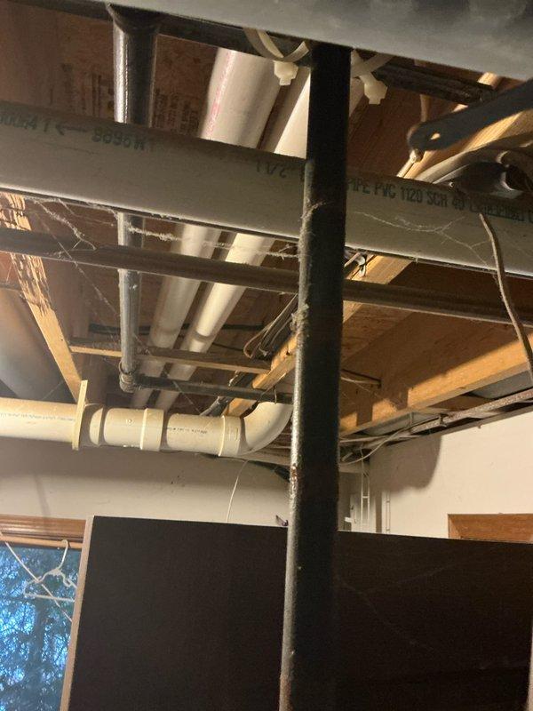 Completed inspection of basement HVAC system with focus on aging furnace unit and associated ventilation components. Documented existing installation including PVC exhaust configuration, water treatment system, and current structural integration within the utility space. Recommended full system replacement due to efficiency concerns and potential ventilation issues observed in the basement ceiling area.