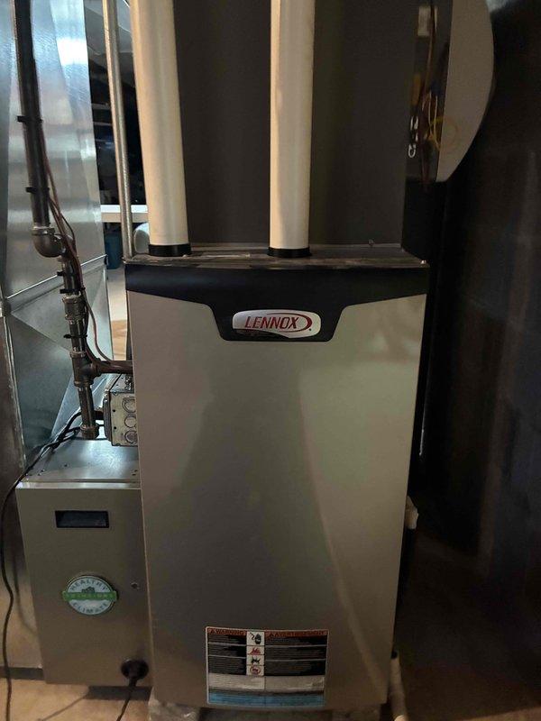 Performed comprehensive tune-up service on customer's Lennox HVAC system. Inspected main furnace unit, associated ductwork, and auxiliary components. Temperature readings confirmed proper system operation at 122.2°F using UEI PDT550 pocket thermometer. All components functioning within normal parameters with no issues detected.