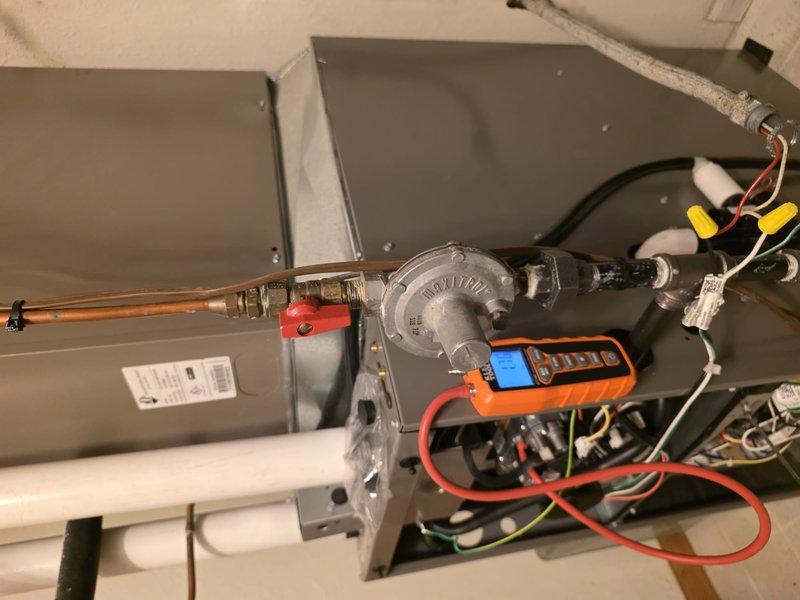 Completed furnace installation in utility room with adjacent water heater. Installed new gas valve regulator with proper copper line connection and conducted pressure testing to verify system integrity. Final inspection confirmed all electrical connections secure with proper ventilation through PVC piping system.