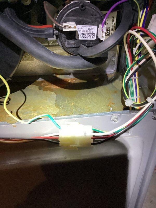 Performed comprehensive tune-up service on HVAC system, inspecting all internal electrical connections and safety components. Checked pressure switch assembly and verified proper operation of the motor/actuator system. Noted minor corrosion on base plate but confirmed all wiring connections are secure and functional with no immediate service concerns.