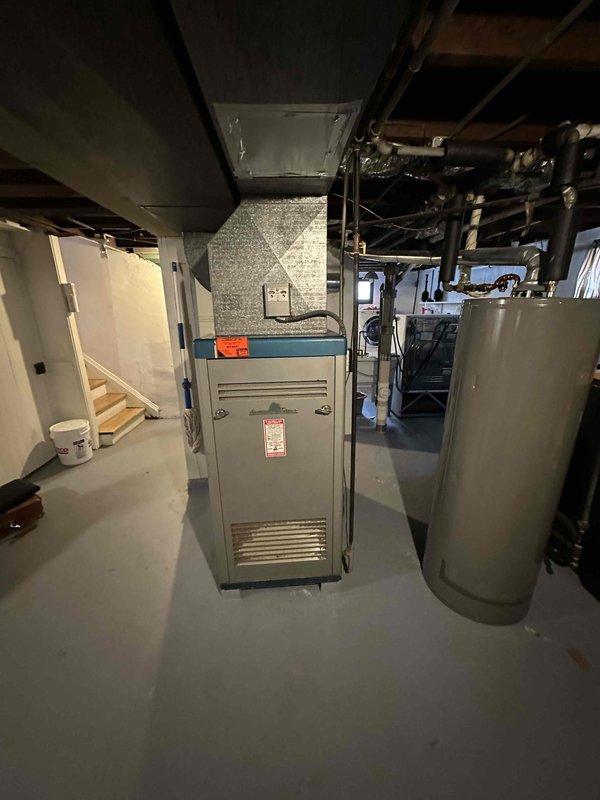 Conducted comprehensive assessment of aging residential HVAC system in basement utility room. Recommended full replacement of existing furnace unit showing warning indicators and visible wear. System inspection revealed outdated ductwork configuration that would benefit from redesign during replacement to improve airflow efficiency.