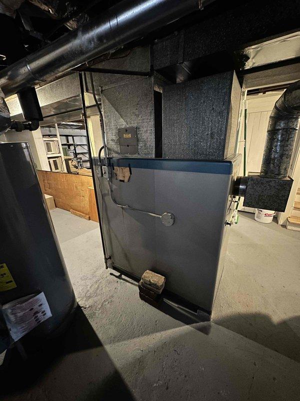 Conducted comprehensive assessment of aging residential HVAC system in basement utility room. Recommended full replacement of existing furnace unit showing warning indicators and visible wear. System inspection revealed outdated ductwork configuration that would benefit from redesign during replacement to improve airflow efficiency.