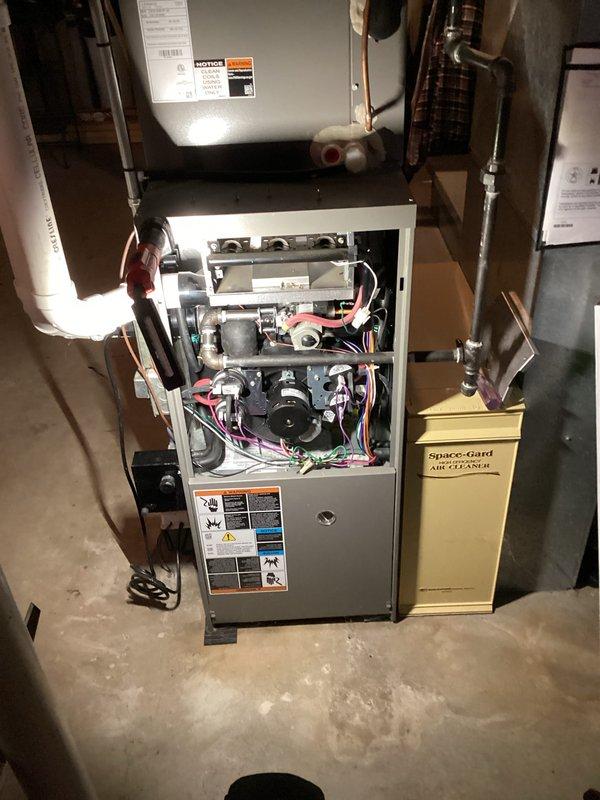 Performed comprehensive tune-up on gas furnace system, including inspection of internal components (blower assembly, motor, gas valve, electrical connections) and verification of proper operation. Examined attached Space-Gard Air Cleaner to ensure optimal filtration. Inspected basement ceiling infrastructure for proper ventilation pathways and confirmed all PVC exhaust/intake pipes were correctly installed and free from obstructions.