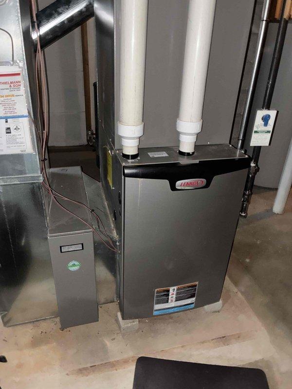 Performed seasonal tune-up on Lennox furnace system. Inspected PVC intake/exhaust venting for proper installation and airflow. Temperature tested system operation with readings at 64.9°F, indicating normal function. Replaced air filter with new Healthy Climate HCF20-11 (20"x25"x5") filter to ensure optimal air quality and system efficiency.