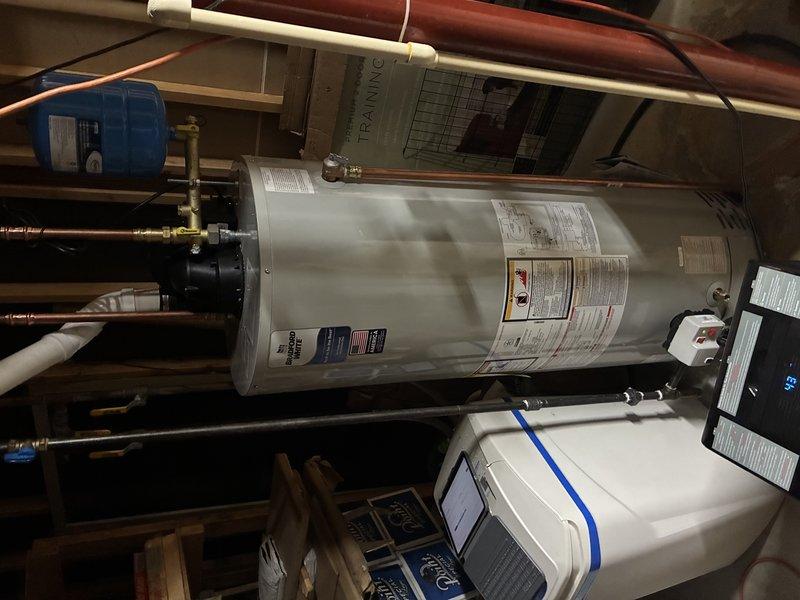 Completed installation of Bradford White water heater system in residential utility room. Installed new copper supply lines with brass valve assembly and ensured proper connection to existing plumbing. All connections were secured and tested for proper operation prior to completion.