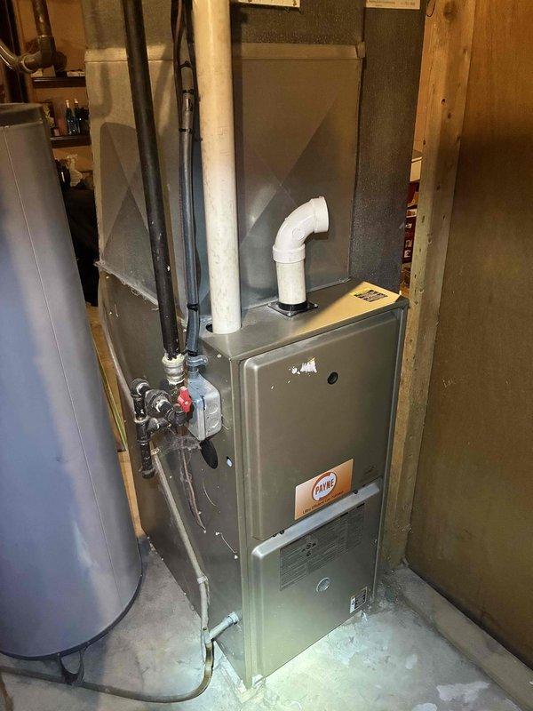 Conducted a comprehensive tune-up of the Payne furnace system in utility room. Inspected interior duct surfaces, noting light dust accumulation and minor corrosion on metal seams. Cleaned components, tested operation, and confirmed proper exhaust ventilation through PVC piping.