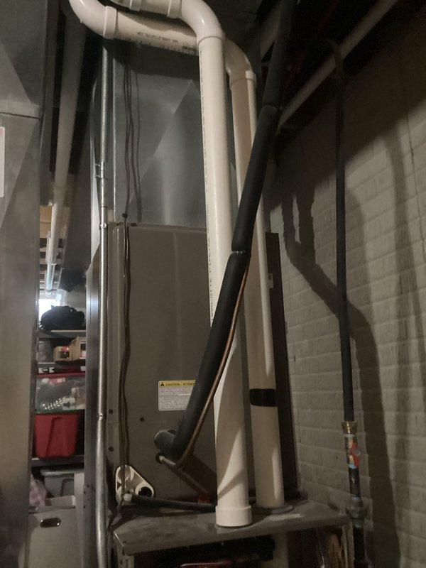 Performed comprehensive tune-up service on residential gas furnace installed in basement. Conducted thorough inspection of all internal components including control board, wiring connections, and exhaust system. Checked PVC venting pipes for proper installation and potential obstructions. Noted possible previous water leak near unit base; recommended monitoring for recurrence. All systems tested operational with no immediate concerns identified.
