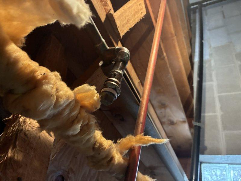 Conducted thorough inspection of under-sink plumbing and attic water supply infrastructure. Identified copper pipe connection issues in the attic crawl space with compromised joint fitting. Documented system components and insulation condition with comprehensive photos to support estimate for fixture replacement.