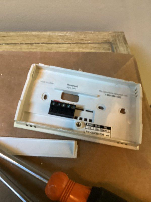 Responded to a no-heat service call for a system less than 10 years old. Upon inspection, determined the thermostat was malfunctioning. Removed the Honeywell thermostat from its base plate to examine wiring connections. Found loose connections at the terminal screws which were preventing proper communication with the heating system. Tightened all terminal connections and verified proper voltage to the thermostat. Remounted the thermostat, tested system operation through a complete heating cycle, and confirmed proper functionality. System is now operating within normal parameters.