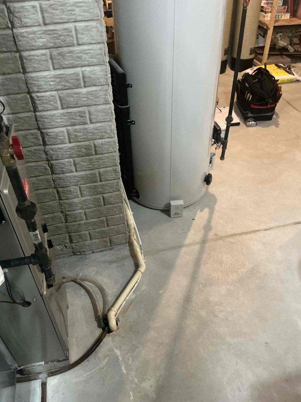 Conducted water heater assessment in basement utility room. Existing unit shows signs of age with potential efficiency concerns. Recommend replacement with newer model that includes updated PVC ventilation system and improved pump assembly to ensure better performance and reliability.