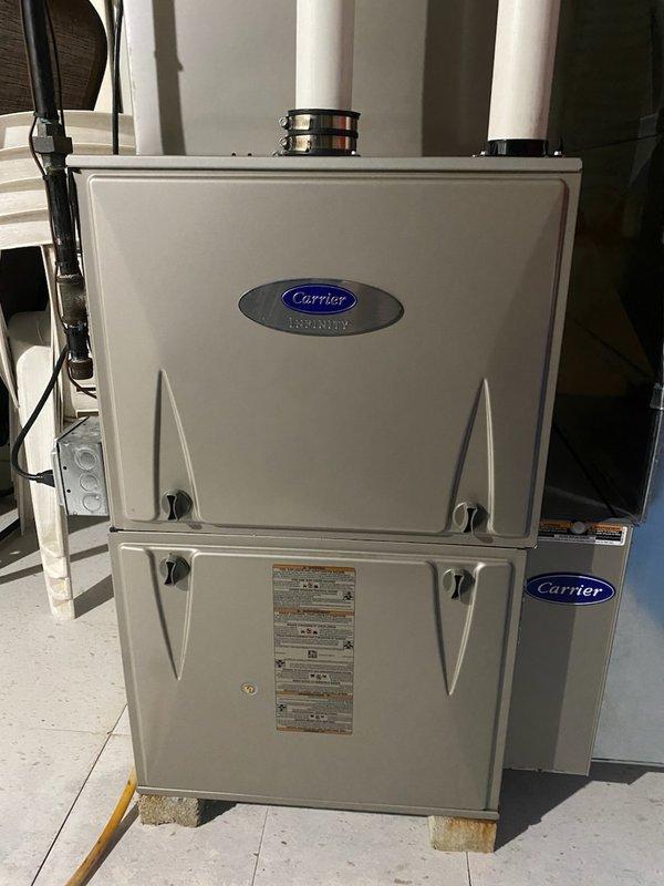 Responded to no-heat service call for Carrier Infinity furnace. Diagnosed failed ECM blower motor based on visual inspection and component testing. Replaced defective motor, recalibrated system, and verified proper operation through complete heating cycle test. Unit now functioning normally with restored airflow.