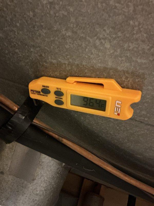 Performed a comprehensive HVAC system tune-up, documenting temperature readings with digital thermometer (recorded 96.48°F). Identified and documented rust-colored staining on insulation material which may indicate moisture intrusion or condensation issues requiring further attention.