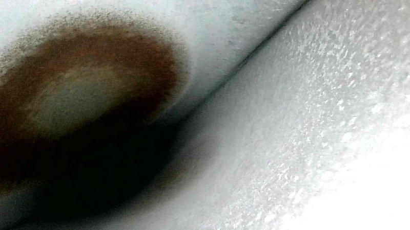 Performed a comprehensive HVAC system tune-up, documenting temperature readings with digital thermometer (recorded 96.48°F). Identified and documented rust-colored staining on insulation material which may indicate moisture intrusion or condensation issues requiring further attention.