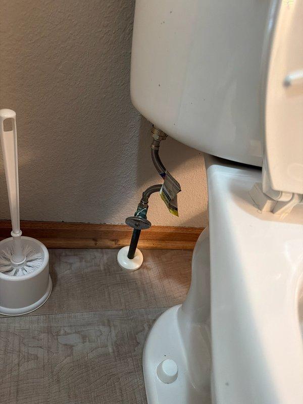 Inspected bathroom fixtures including toilet installation with proper water supply connection and a shower system equipped with dual showerheads. Noted some mineral buildup on the rainfall showerhead that may require future maintenance. All plumbing connections appear secure and functional.