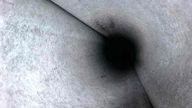 Performed routine HVAC tune-up service, including visual inspection of ductwork system. Documented moderate dust accumulation in ventilation shafts with some visible seam integrity concerns. Interior duct examination revealed minor sooting and potential particulate buildup requiring future attention, particularly near junction points.