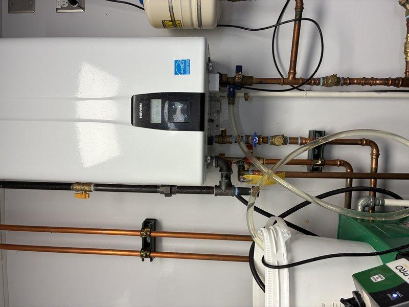 Installed new water heating system with proper copper piping network and connections. System features digital control panel and Energy Star certification. Installed condensate pump system with collection bucket to manage discharge from the unit.