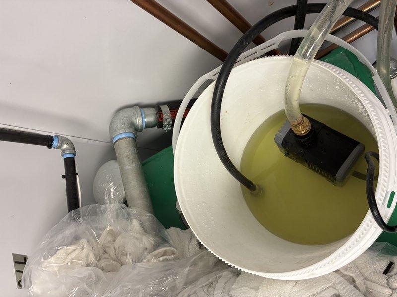 Installed new water heating system with proper copper piping network and connections. System features digital control panel and Energy Star certification. Installed condensate pump system with collection bucket to manage discharge from the unit.