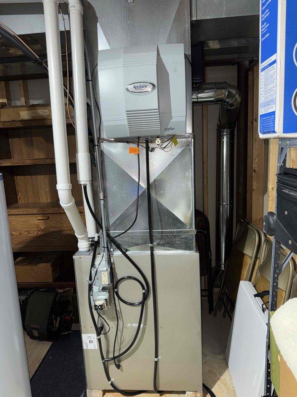 Performed routine tune-up on residential HVAC system with Aprilaire whole-house humidifier. Inspected furnace components, electrical connections, and condensate drain lines. Verified proper operation of humidifier and checked adapter plate and mounting hardware for secure installation. All components functioning normally with no issues detected.