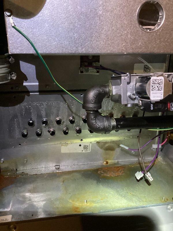 Performed comprehensive inspection of HVAC unit showing significant internal corrosion on metal chassis and components. Replaced rusted pipe fittings and elbow joints that were causing moisture accumulation. Cleaned corroded surfaces and verified proper operation of motor assembly, control module, and wiring connections to restore system functionality.