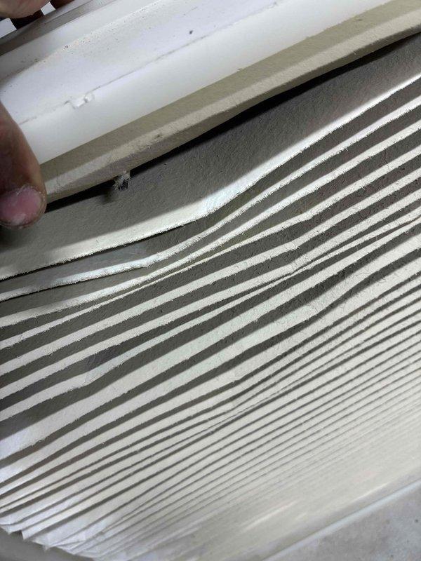 Completed routine HVAC tune-up service which included inspection of system components. Examined and documented condition of the pleated air filter, noting moderate dust accumulation in the filter pleats. Inspected interior galvanized metal ductwork for integrity, finding the main junction and access panel in serviceable condition with normal wear.