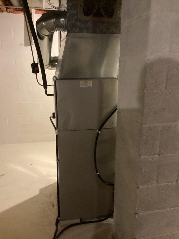 Successfully installed new furnace unit in basement utility room, complete with proper connection of all necessary ductwork, electrical components, and gas lines. Installation included positioning the unit in corner location with limited space, securing all connections, and verifying proper operation before completion.