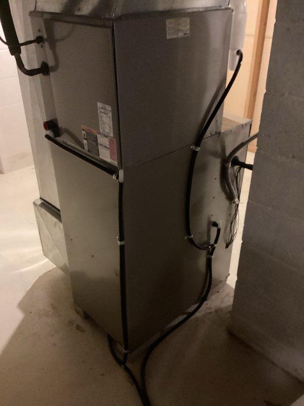 Successfully installed new furnace unit in basement utility room, complete with proper connection of all necessary ductwork, electrical components, and gas lines. Installation included positioning the unit in corner location with limited space, securing all connections, and verifying proper operation before completion.