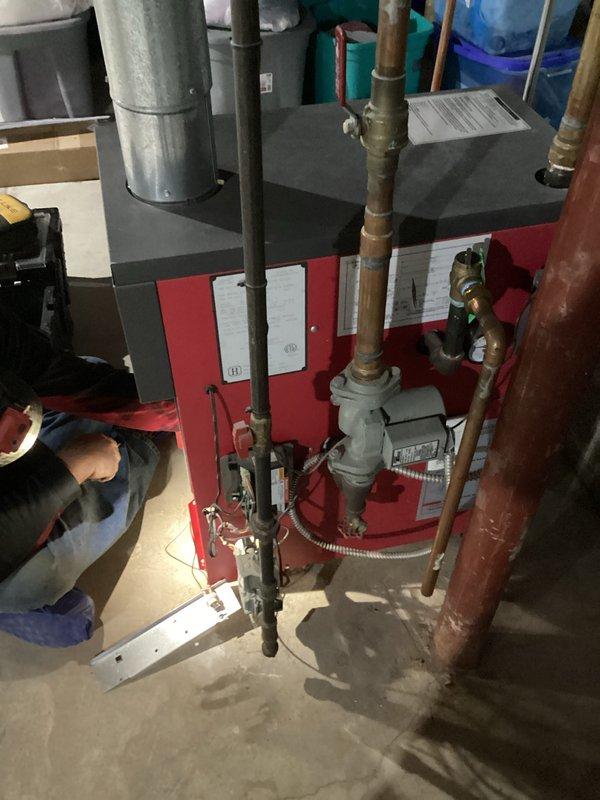 Performed comprehensive tune-up service on Crown boiler system located in basement utility area. Inspected all components including circulator pump, copper piping connections, and metal vent stack for proper installation and operation. Cleaned and tested system, confirming optimal performance with no issues detected in the heating equipment.