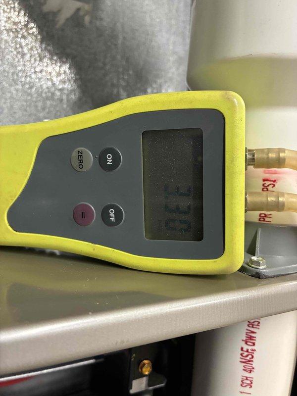 Performed diagnostic pressure testing on the furnace system using manometer, obtaining baseline reading of 0.0. Inspected drainage assembly including PVC pipe connections and shutoff valve functionality. Confirmed proper operation of water management components related to furnace operation.