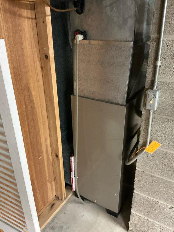 Completed comprehensive assessment for HVAC system replacement, including inspection of aging outdoor air conditioning condenser showing significant weathering and the existing indoor furnace unit installed against basement wall. Documented current system condition with photos, noting ventilation, electrical connections, and mounting configurations to prepare detailed replacement proposal.