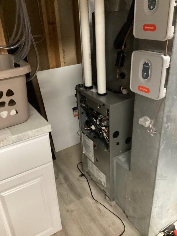 Performed routine tune-up on residential HVAC system, including inspection of the furnace unit and associated Honeywell control components. Examined PVC ventilation piping and connections for proper installation and functionality. Confirmed all electrical wiring connections were secure and operational. System is now functioning within normal parameters.