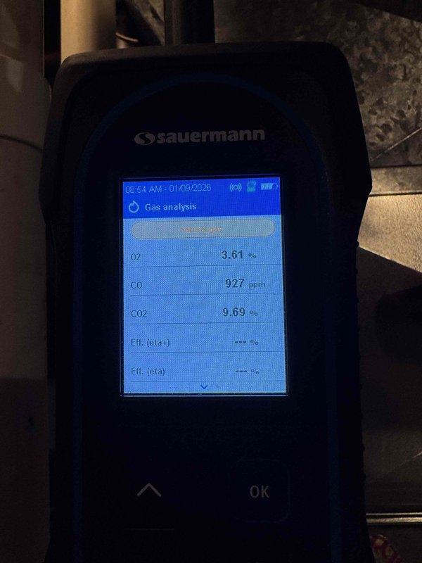 Performed diagnostic gas analysis on heating system using Sauermann analyzer, which detected elevated carbon monoxide (CO) levels between 927-1139 ppm, indicating combustion issues. Oxygen levels measured at 3.23-3.61% with CO₂ readings around 9.7-9.9%, suggesting improper air-fuel mixture requiring adjustment or possible heat exchanger inspection.