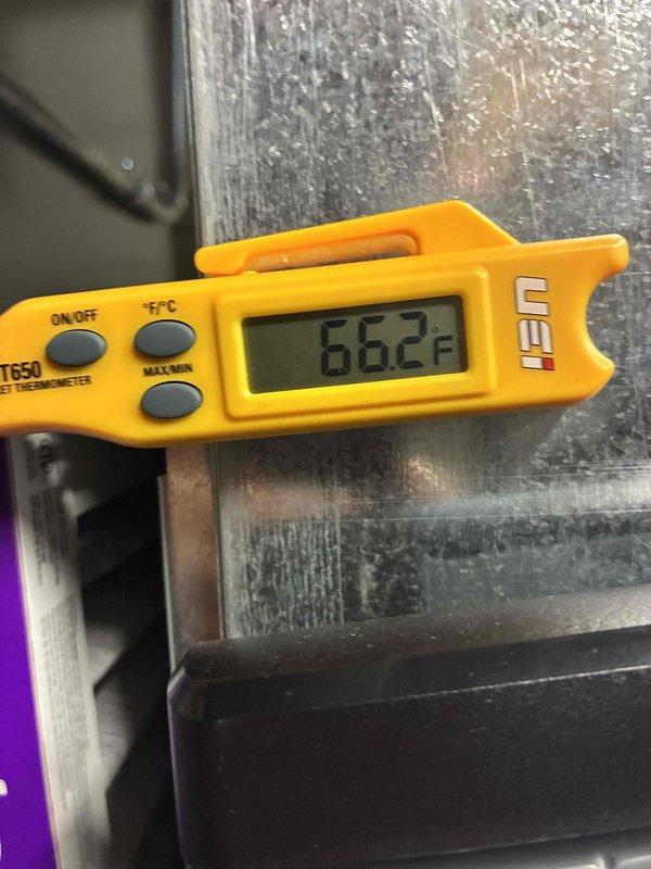 Performed routine HVAC tune-up service including temperature verification with digital thermometer (reading 66.2°F on system components) and electrical diagnostics with SC680 multimeter showing 10.6 μA DC current draw. System operating within normal parameters after inspection and testing of critical components.