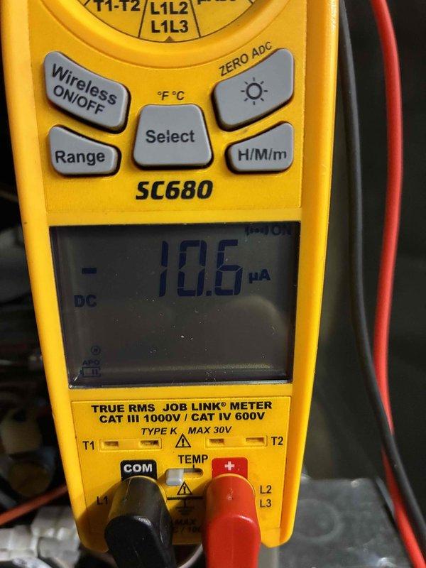 Performed routine HVAC tune-up service including temperature verification with digital thermometer (reading 66.2°F on system components) and electrical diagnostics with SC680 multimeter showing 10.6 μA DC current draw. System operating within normal parameters after inspection and testing of critical components.