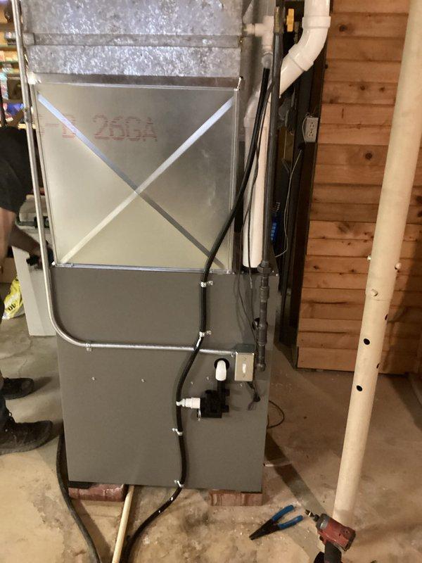 Successfully installed a new residential furnace system in basement utility room. Unit was properly secured and connected to existing ductwork with proper X-bracing. All PVC venting, condensate lines, and electrical connections were completed according to manufacturer specifications.