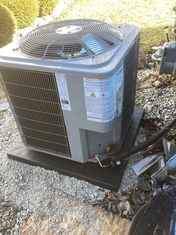 Successfully installed a complete Carrier HVAC system including indoor furnace unit with metal ductwork in basement mechanical area and outdoor condenser unit. Outdoor unit was properly mounted on a gravel bed with plastic/concrete pad foundation, with all necessary refrigerant lines and electrical connections completed. System is operational with no issues observed.