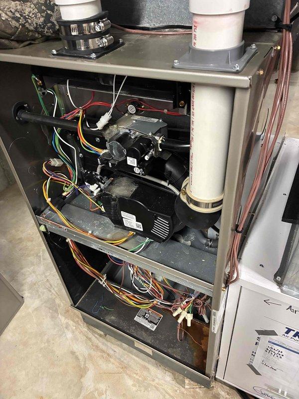 Performed comprehensive tune-up on residential HVAC system. Inspected interior components including blower motor assembly, circuit board, gas valve, and ignition system. Cleaned accumulated dust from internal components and verified proper wire connections throughout the unit.