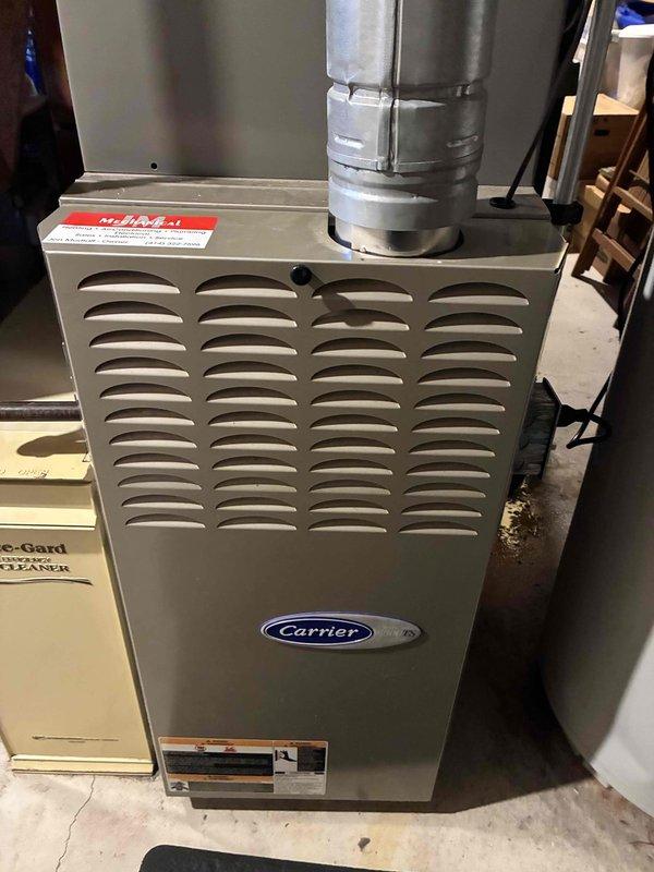 Performed annual preventive maintenance on a residential Carrier furnace unit located in the basement mechanical room. Conducted full electrical diagnostic testing with SC680 multimeter, checking amperage readings (3.0 mA) to verify proper component operation. Visual inspection revealed system to be in normal operating condition with no visible damage or anomalies to the furnace or connected ventilation components.