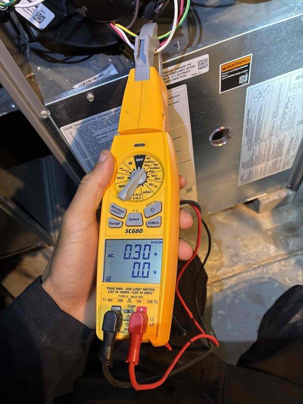 Performed standard HVAC maintenance service on unit. Conducted electrical testing with SC680 clamp meter, verifying current draw at 0.30A. Inspected burner assembly showing proper combustion with uniform blue flame pattern, indicating efficient operation.