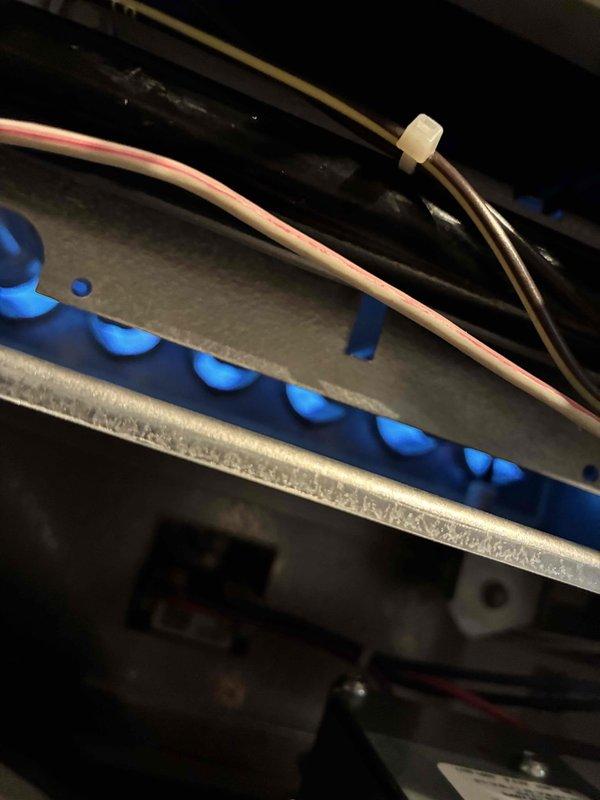 Performed standard HVAC maintenance service on unit. Conducted electrical testing with SC680 clamp meter, verifying current draw at 0.30A. Inspected burner assembly showing proper combustion with uniform blue flame pattern, indicating efficient operation.