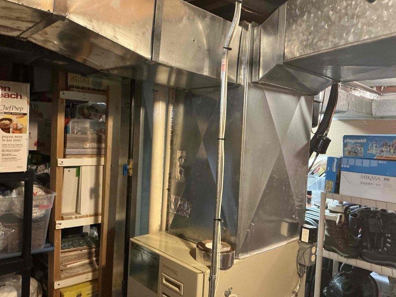 Performed visual assessment of existing HVAC system in basement utility area. Current unit is an aging beige/tan furnace with standard vertical design and connected ductwork. System evaluation indicates replacement is recommended with appropriately sized equipment to ensure optimal performance and efficiency for the home.